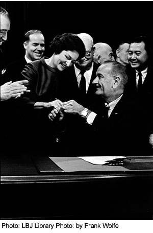 LBJ gives Lady Bird the pen he used to sign her 1965 Highway Beautification Act