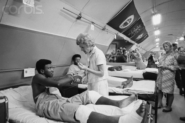 83. The First Lady visited a wounded soldier in an evacuation hospital just outside of Saigon in July, 1969.