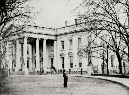 A photo of the White House's north side with a little boy standing on the drive, recently identified as Tad Lincoln.