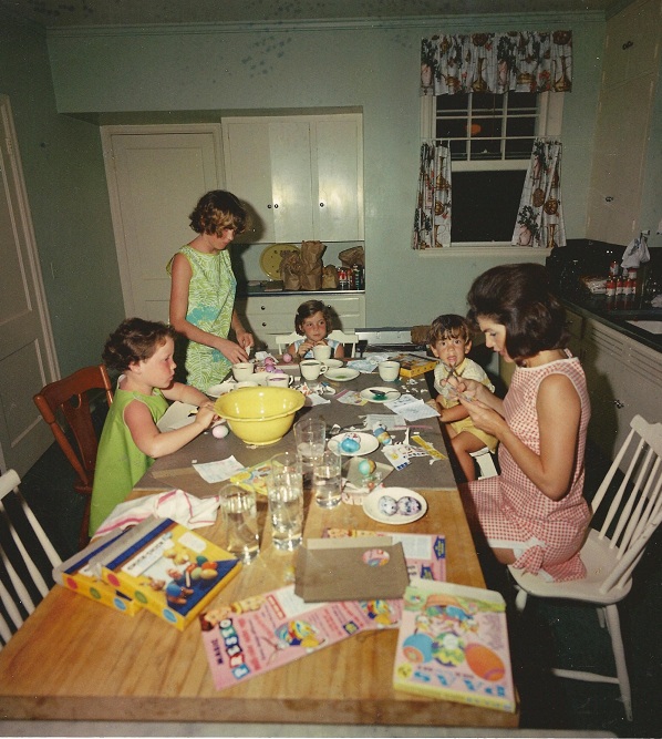 Jackie Kennedy coloring eggs with her son John. Her daughter Caroline and family friend Sally Fay at Eastertime 1963.