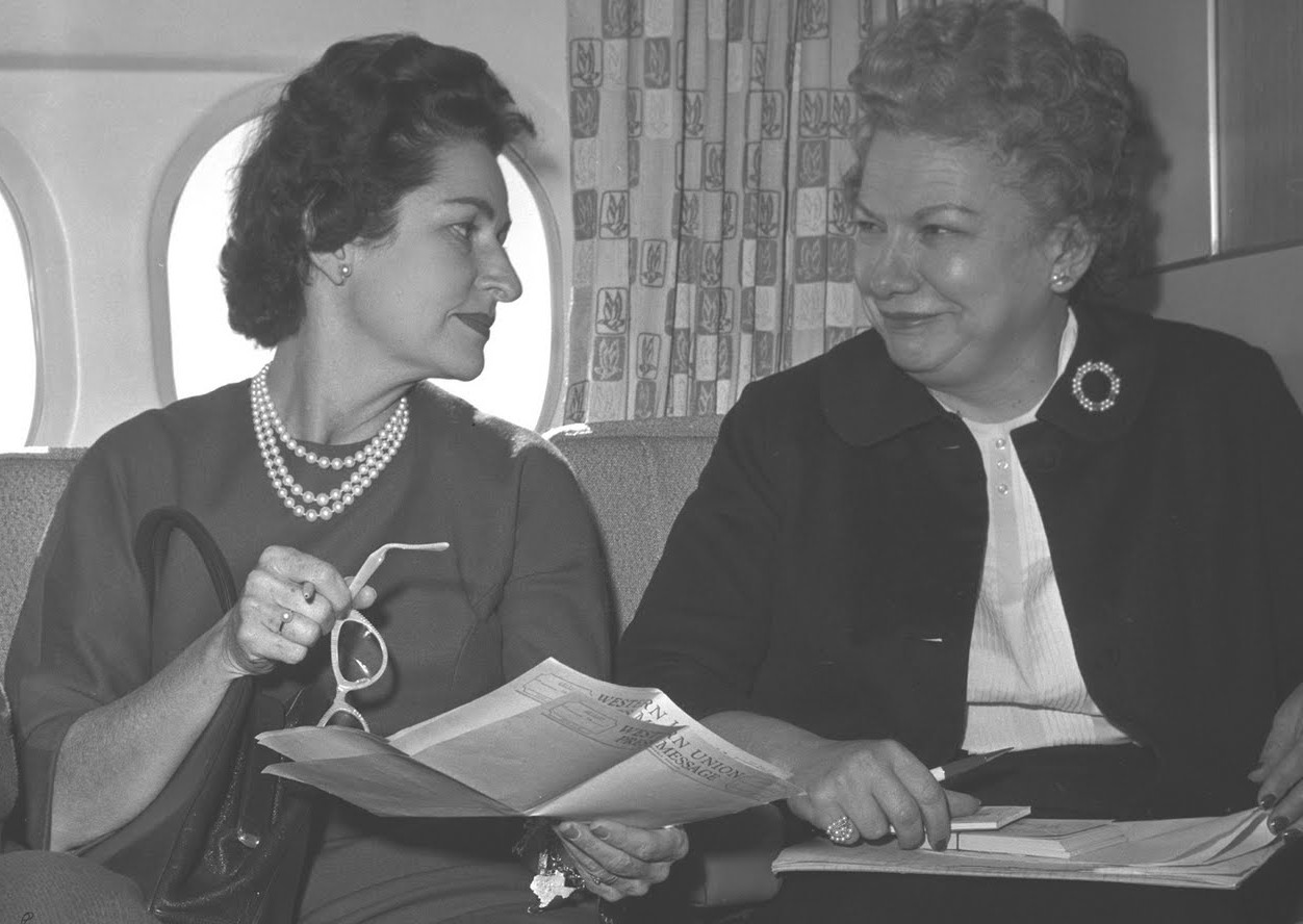 Lady Bird Johnson consults with her friend and Press Secretary Liz Carpenter who introduced her and LBJ to her friend Carol Channing.