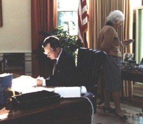 Just seven days after he became President, Barbara Bush looks over her husband's Oval Office, during which time he was said to be passing out gift bags of pork rinds to guests.