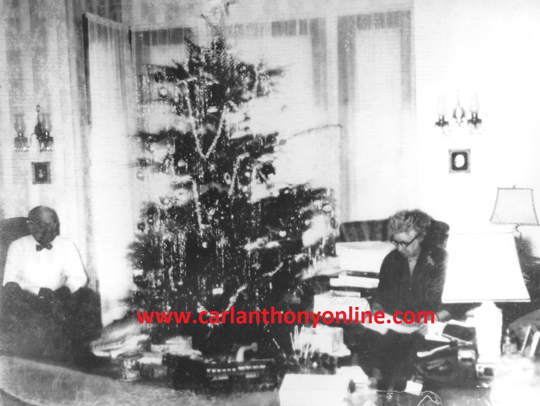 A family snapshot of the President and Mrs. Truman after opning their Christmas gifts.