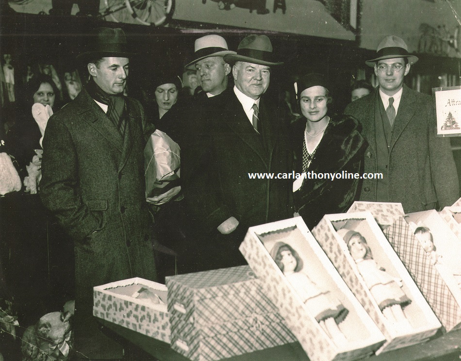 Herbert Hoover, his two sons and daughter-in-law Christmas shopping for his granddaughter in a toy store.