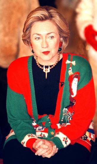 Hillary Clinton in a very Christmas sweater, one of her early gifts given so she could wear it throughout the Holiday Season..