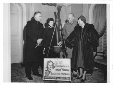 Mamie Eisenhower lends a hand and donates some money to the Salvation Army.