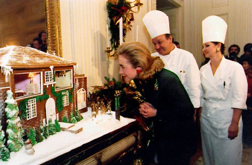 Mrs. Clinton looks into a gingerbread house of her childhood home.