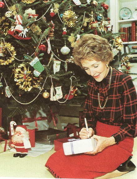 Mrs. Reagan writing out gift labels for the Christmas presents she bought, for the family's own tree.