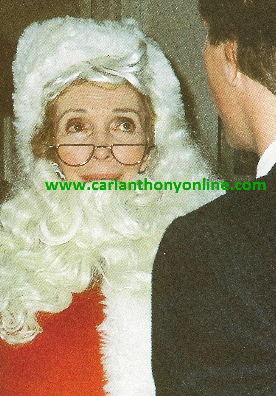 Nancy Reagan enjoying playing the Santa role at a Christmas Eve party with her friends, the Wick family.