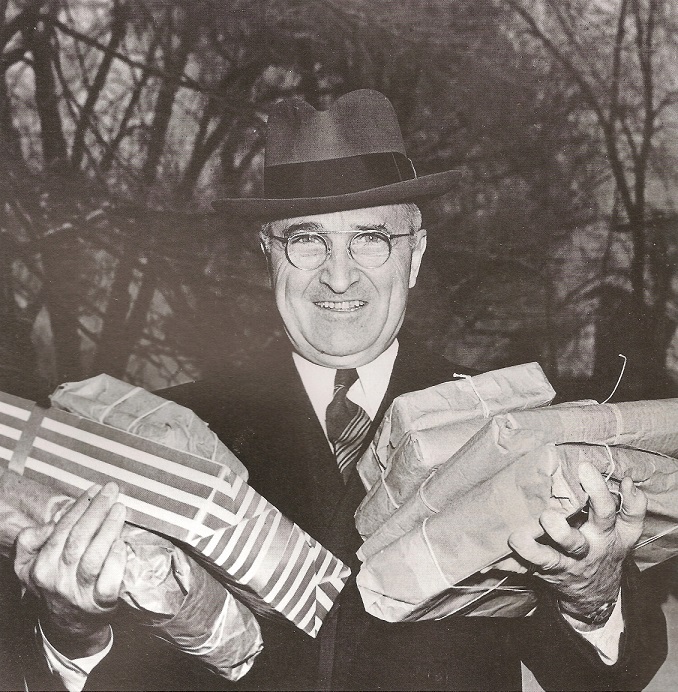 President Harry Truman carrying holiday presents he bought, 1945.