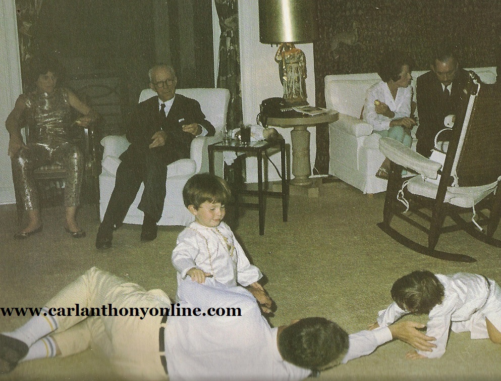 President Kennedy plays with his son and nephew on Christmas Eve 1962 in Palm Beach, his sister and father at left, his mother and brother-in-law at right.