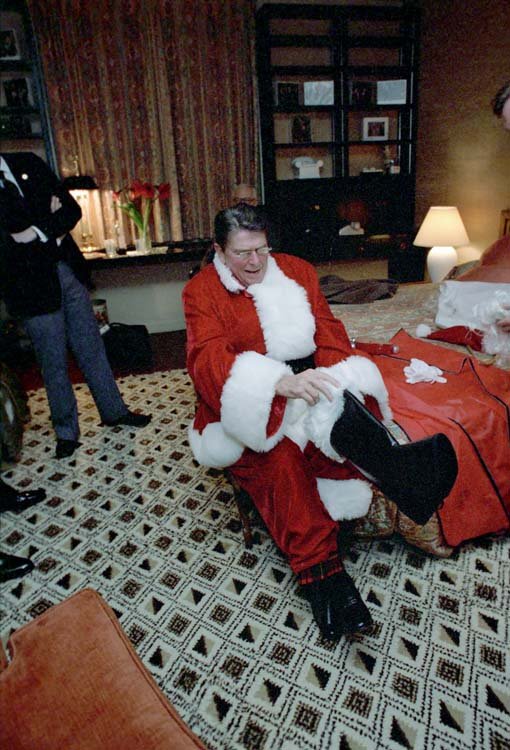 Ronald Reagan dresses up as Santa Claus at a friend's party.