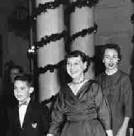 Seen here with her grandson and daughter-in-law, Mamie Eisenhowers had the Cross Hall columns wrapped with evergreen garlands.