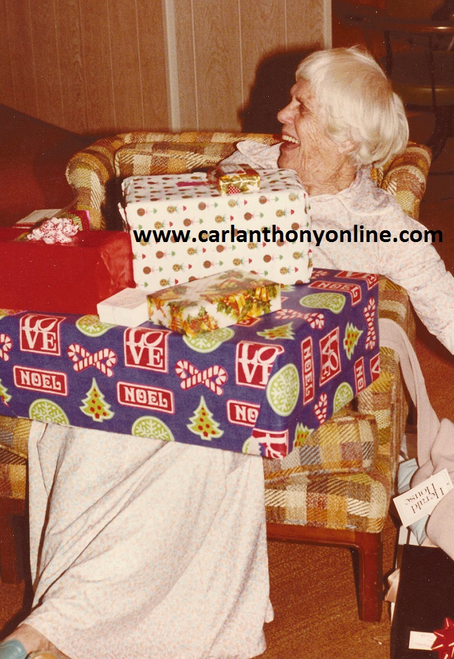The President's mother, Lillian Carter, piled high with her presents.