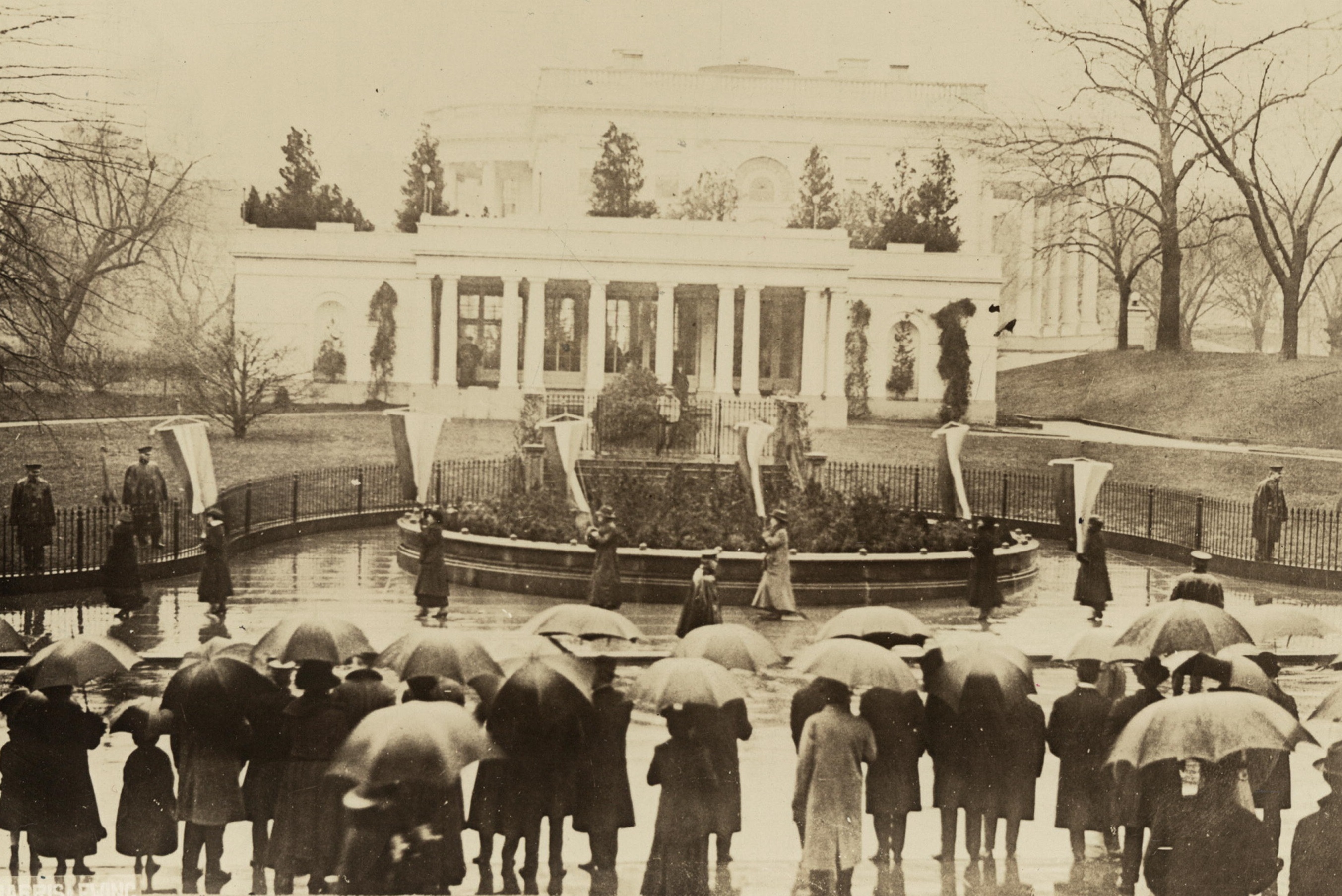 Suffragists picketing Wilson's 1917 Inauguration on the east side of the White House.