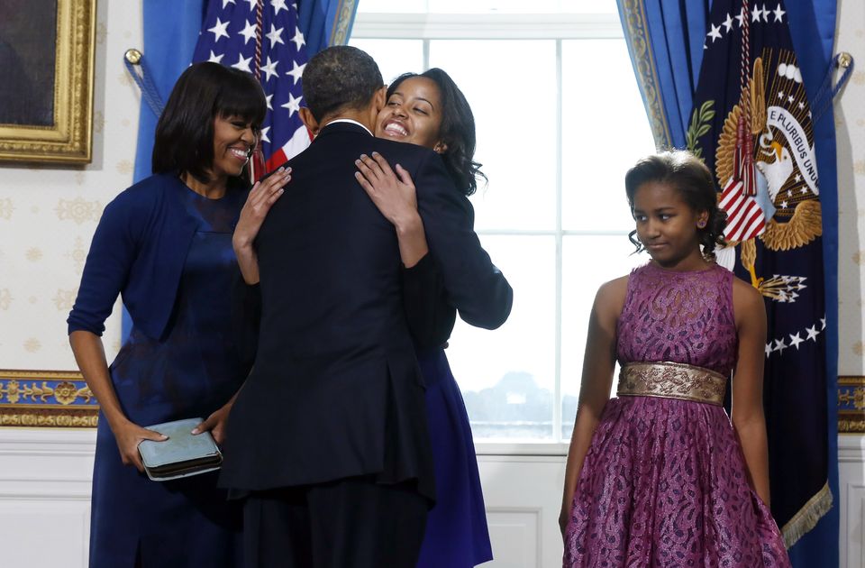 The President's eldest daughter Malia embraces her father following the first of two swearing-in ceremonies for his second term, January 20, 2013.