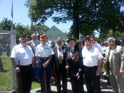 Veterans of World War II and the Korean War stand together.