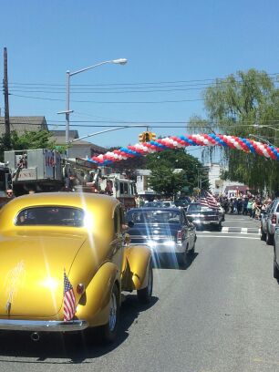 The parade begins with cars from decades past.