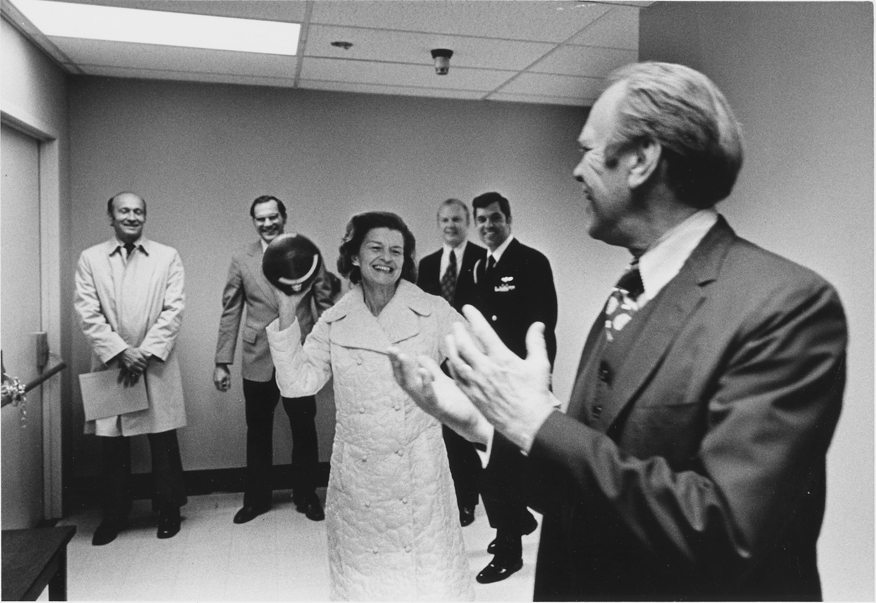 The President catches a toss thrown by First Lady Betty Ford as they create a lighthearted distraction before she underwent breast cancer surgery, 1974.