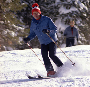 President Ford skiing, followed by Secret Service agents who had to learn to ski well enough to keep up with him.
