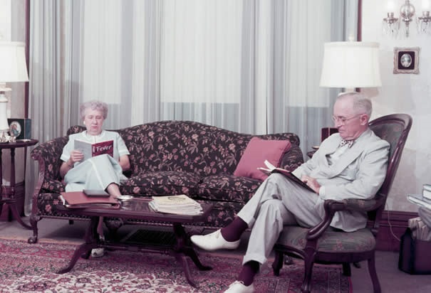 Harry and Bess Truman reading in their Missouri parlor. (Truman Library)