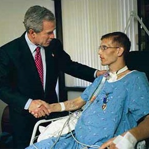 President Bush with a wounded Iraqi war veteran. (GWBL)