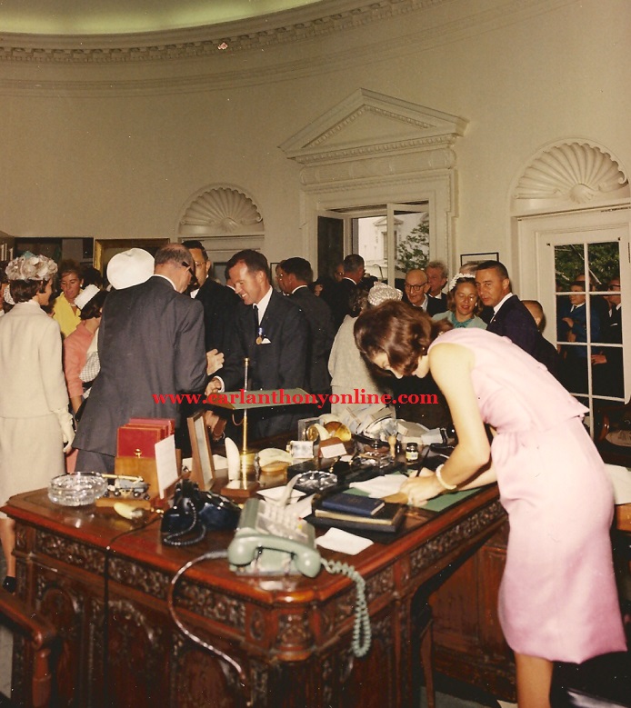 Jacqueline Kennedy writing on the President's Oval Office desk n the spring of 1963.