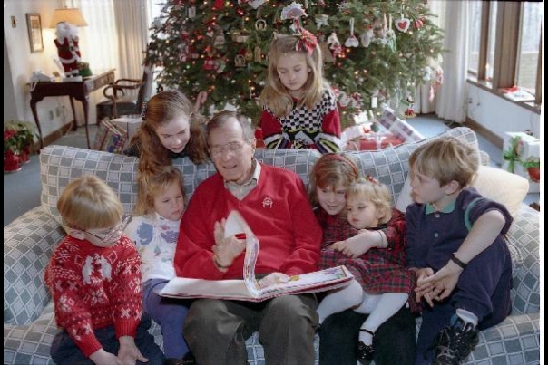 George Bush reads The Night Before Christmas to some of his grandchildren at Camp David where they spent Christmas in 1991.