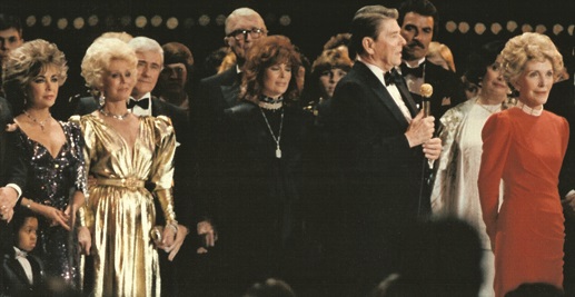 Liz Taylor, Eva Gabor, Jimmy Stewart, Jill St. Johnson behind the Reagans on stage at the '85 Gala.
