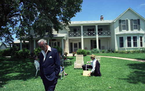 The brooding, desolate former President Johnson walking away from ranch guests.